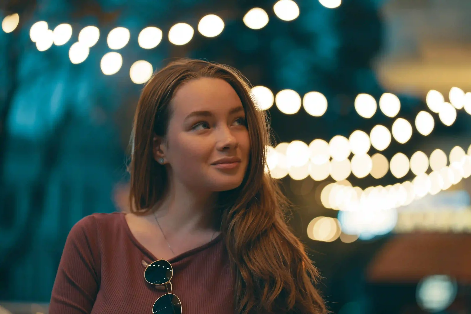 Portrait with a shallow depth of field and city-light bokeh behind the subject