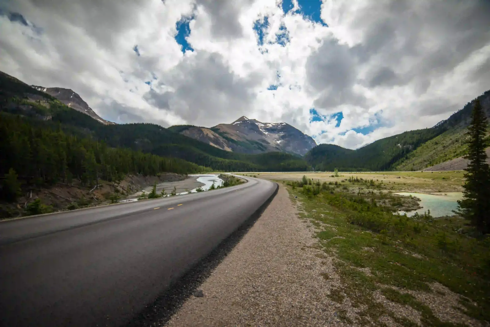 Road leading the eye toward distant mountains, an example of leading lines